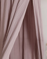 a close up of a curtain with a clock on it